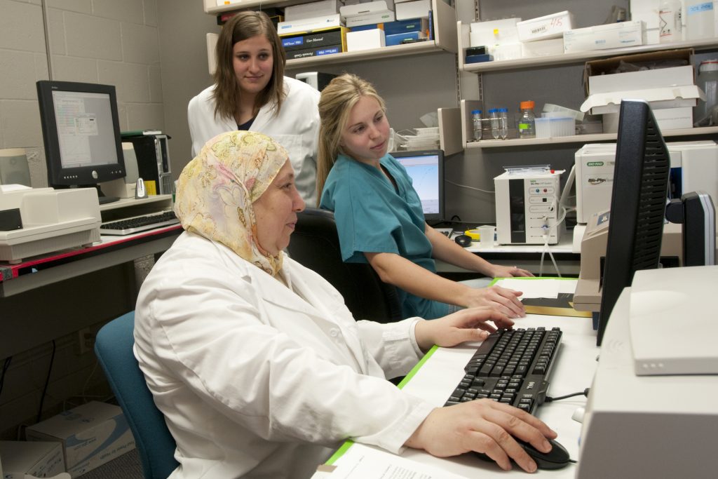 Scientists looking at screen