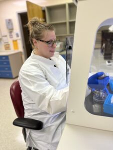 Dr. Shoshannah Eggers pipetting samples in a fume hood.